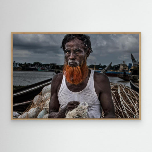 A man from Bangladesh untangling nets. by Joxe Inazio Kuesta Garmendia