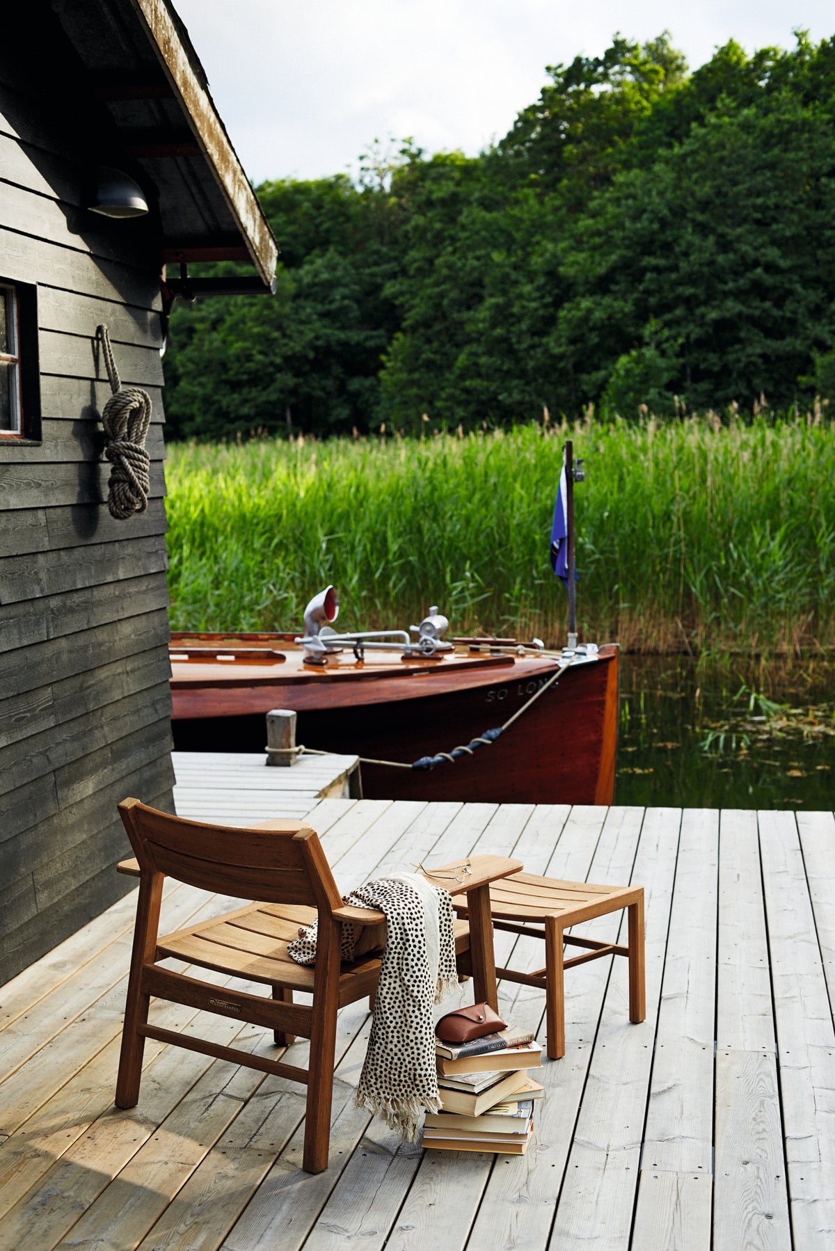 Djurö teak dining armchairs on a terrace