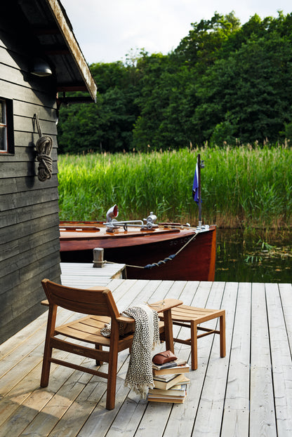 Djurö teak dining armchairs on a terrace