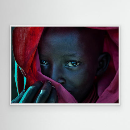 Ethiopian child covered in a red robe. by Joxe Inazio Kuesta Garmendia