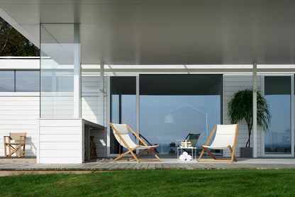 H55 teak lounge chair in a setting