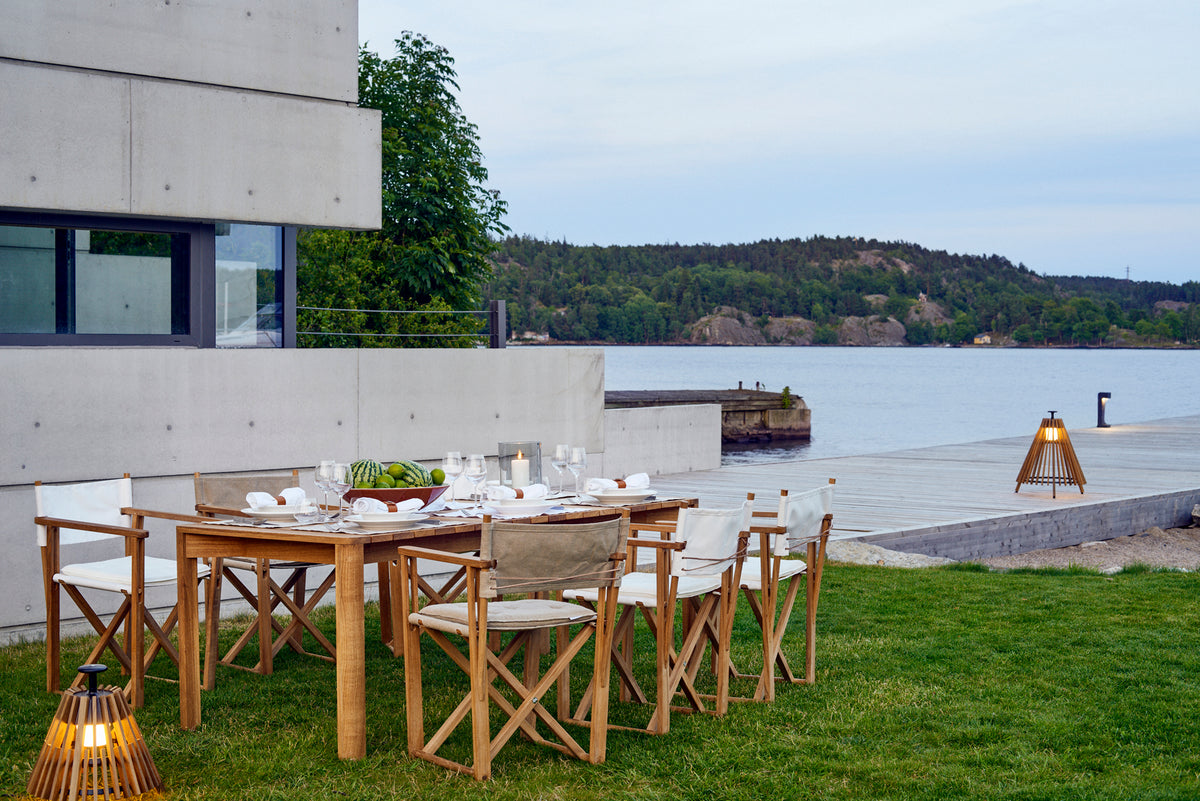 Kryss dining chairs on a terrace by the sea