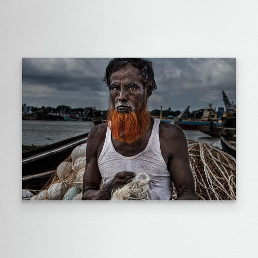 A man from Bangladesh untangling nets. by Joxe Inazio Kuesta Garmendia